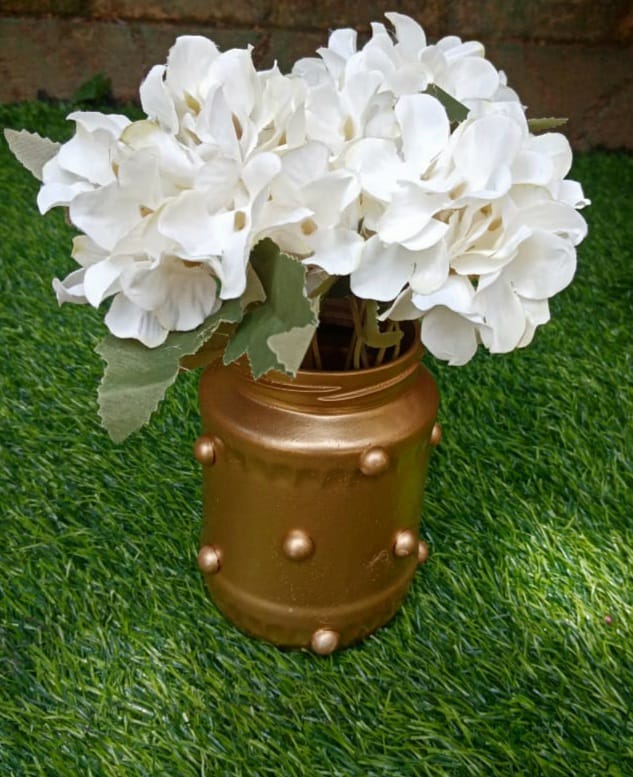 Gold jar with white hydrangea flower